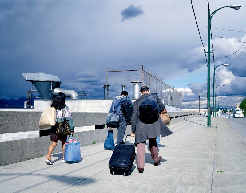 Jeff Wall, Overpass. Three people cross a flyover or bridge.